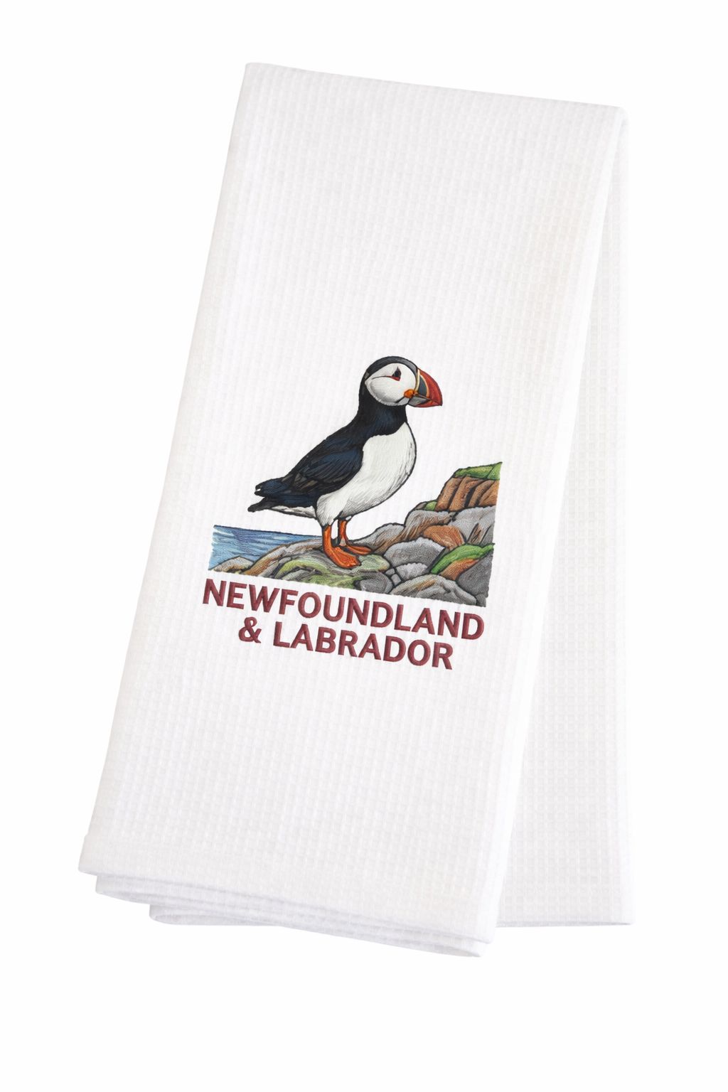 White waffle weave tea towel with a puffin on the rocks and Newfoundland & Labrador underneath